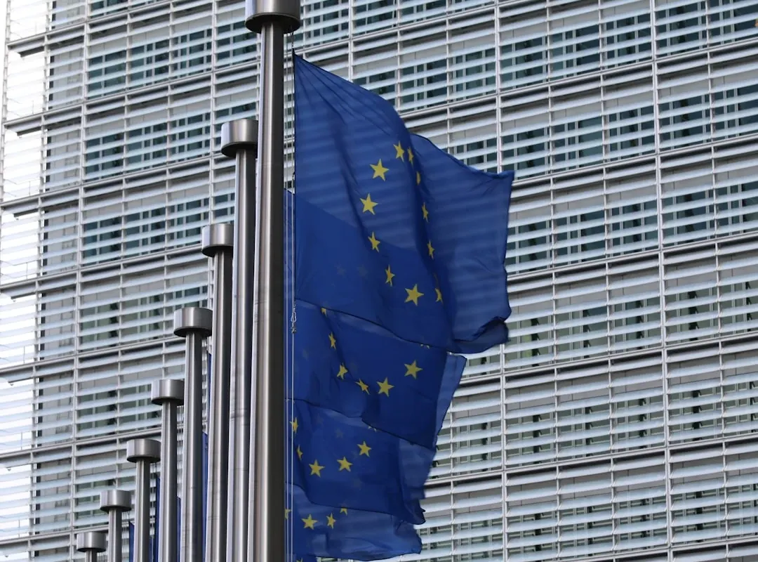 European Union flag outside an institutional building, symbolising EU and national grant funding for startups