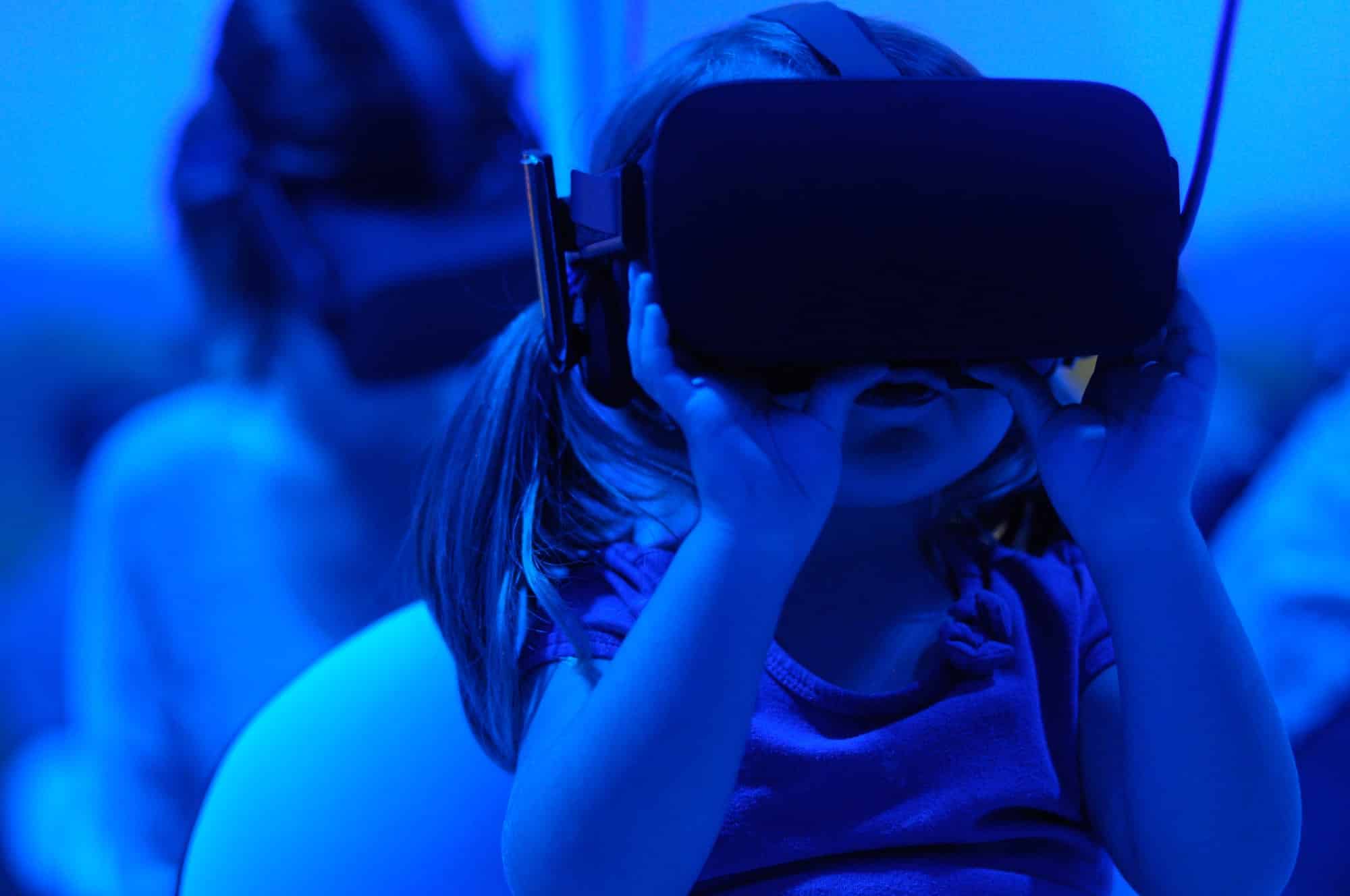 A toddler child wearing a VR headset