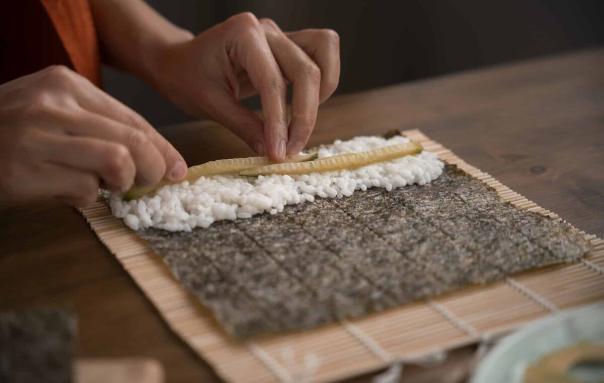 Side view woman learning make sushi