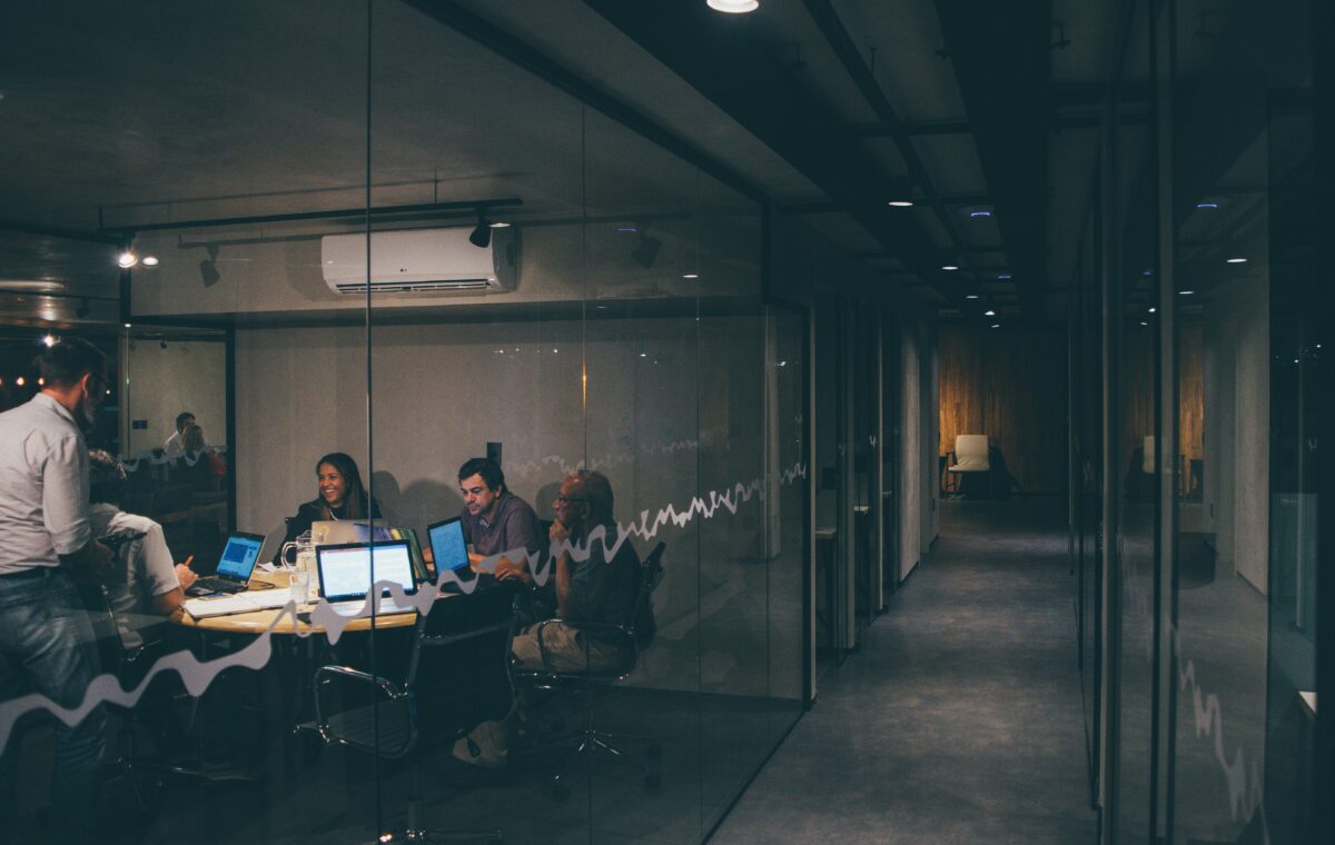 Startup team discussing a seed funding pitch around an office meeting table